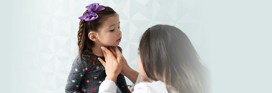 Physician doing a physician exam of a child's thyroid 