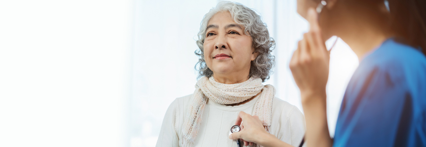 Doctor with stethoscope examining elderly patient with examination, presenting symptoms and recommending treatment, healthcare and medical concept.