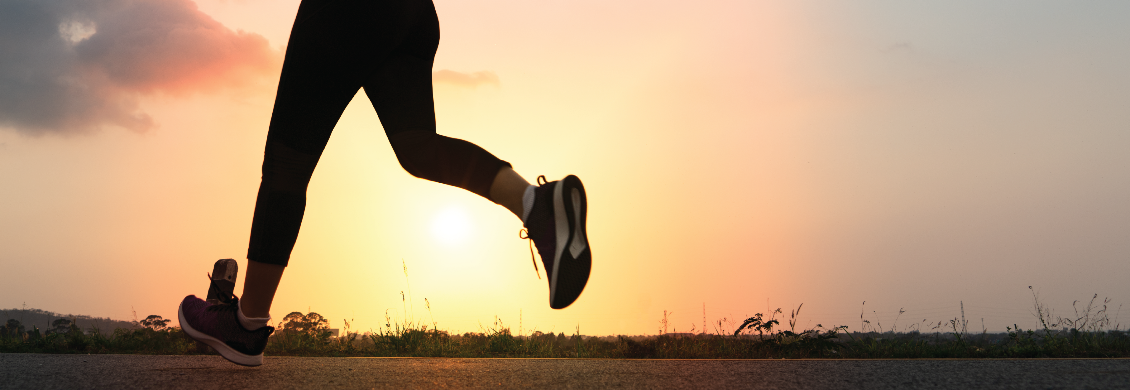 A close up of a woman's feet while running at sunrise