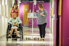 Pediatric patient with caregivers in hallway