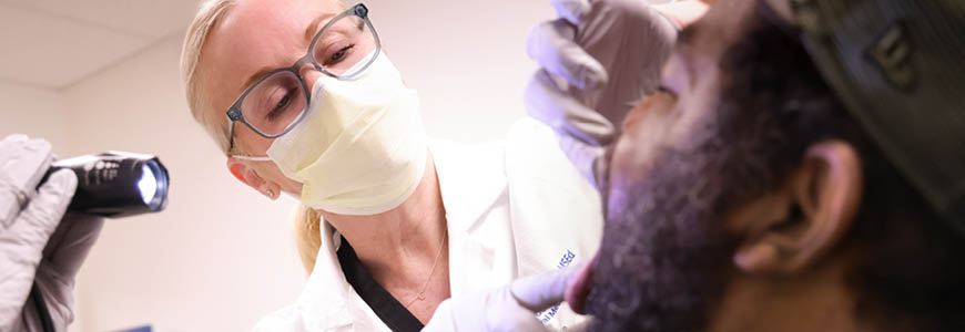 Physician looking into patient's throat