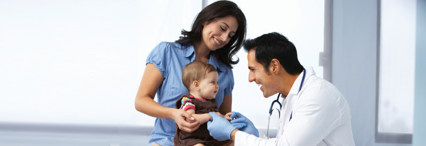 Doctor greeting child and mother