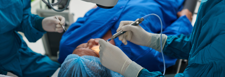 Physician performing surgery on eye