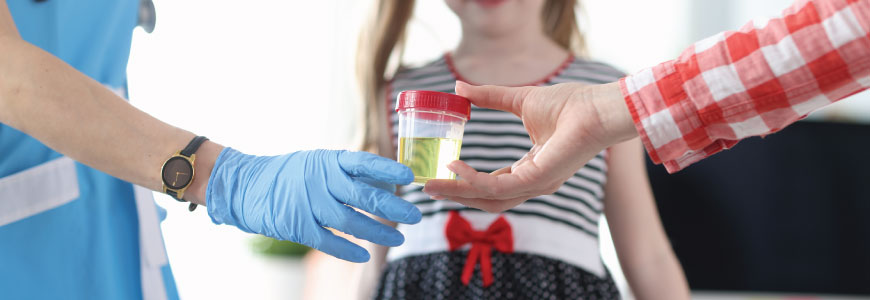 Parent passing child's urine sample to medical provider