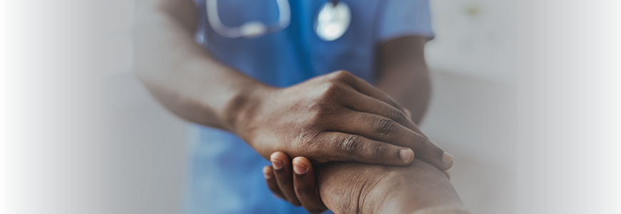 Provider holding black patient's hand