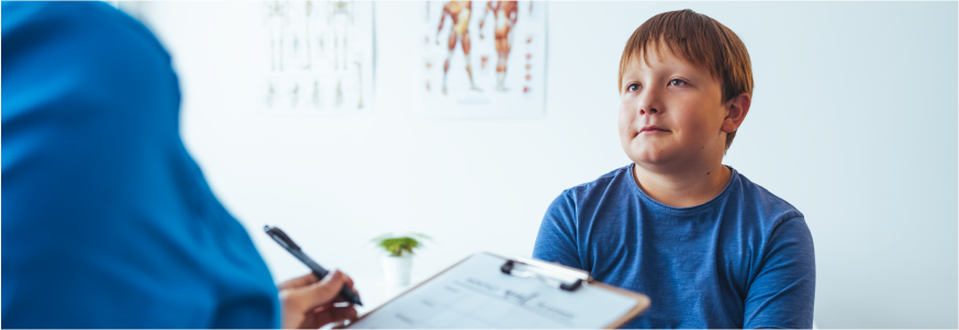 Teenage boy and doctor have a consultation in a clinic room