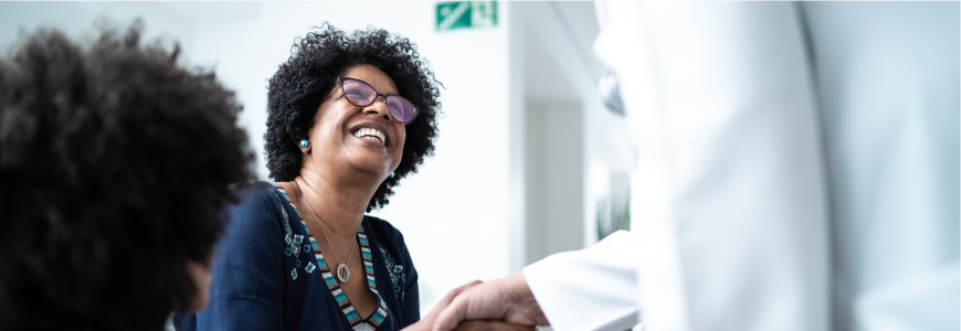 Doctor greeting mother and daughter