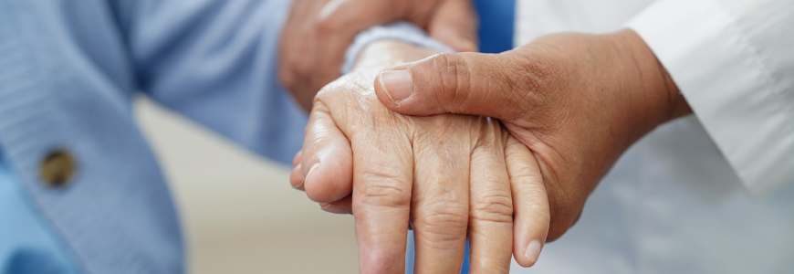 Physician examining patient's hand tremor