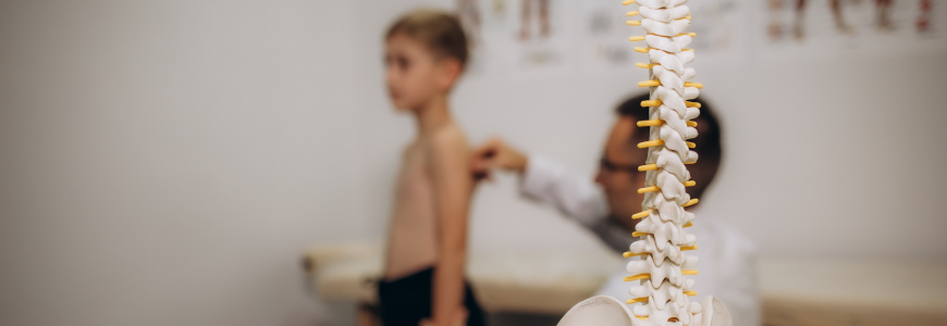 Doctor examines the back of a 5-year-old boy who has back pain