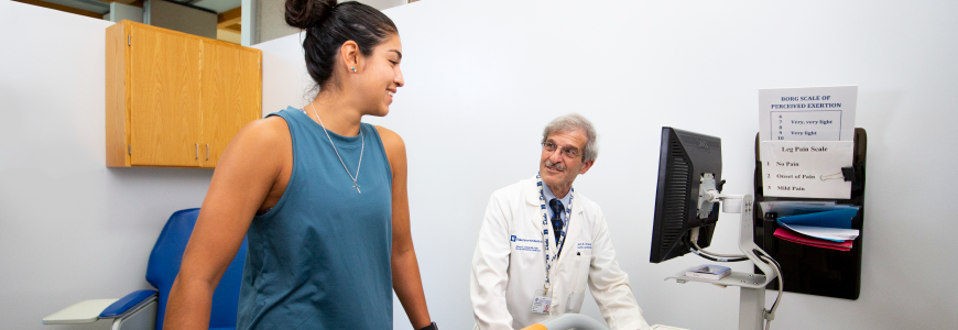 Patient walking on treadmill with physician supervision