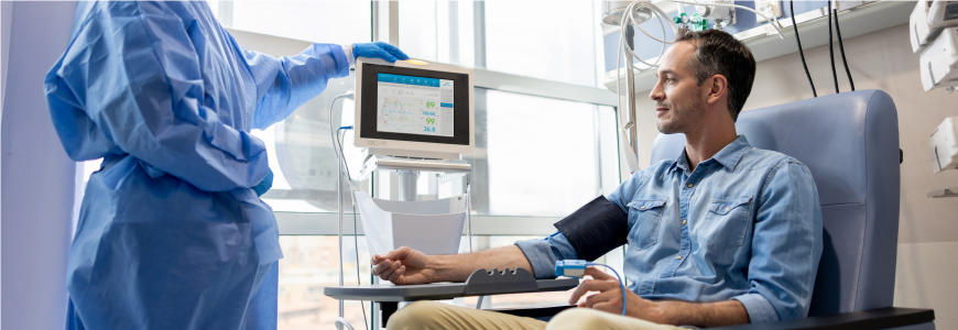 Oncology nurse checking the vital signs of a chemotherapy patient at the hospital