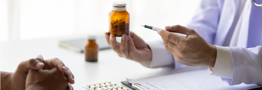 Specialized doctor is explaining taking medicine to a patient.