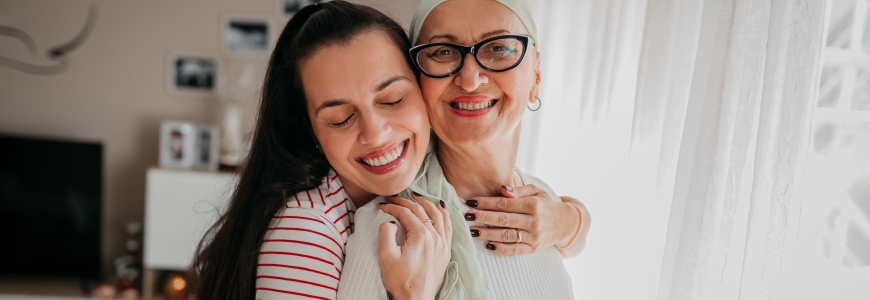 Daughter arranges a scarf for her mother, cancer