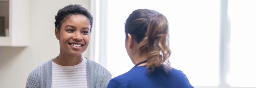 Mid adult woman receiving good news from nurse