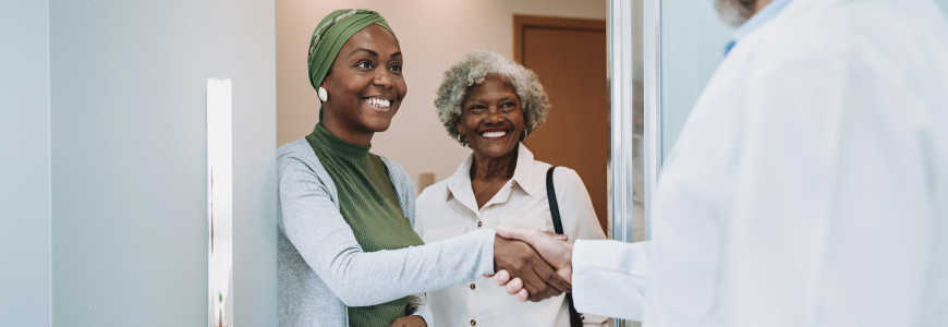 Adult daughter with cancer visits doctor with senior mother