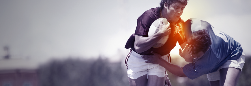 A rugby player being tackled during a game and sustaining an injury