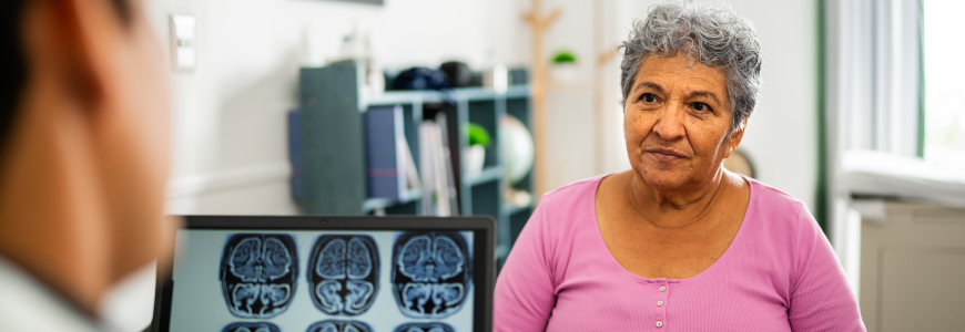 Senior woman talking to doctor during consultation at hospital