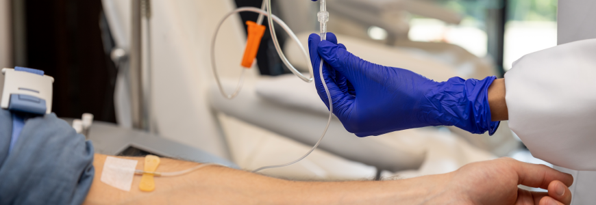 Man receiving infusion drip in hospital