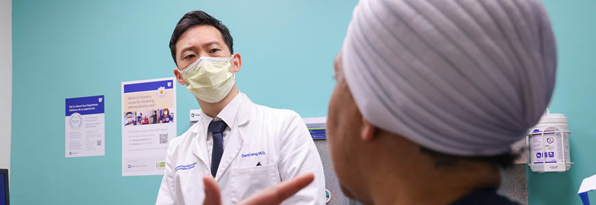 Dr. Jang talking with a patient during an exam