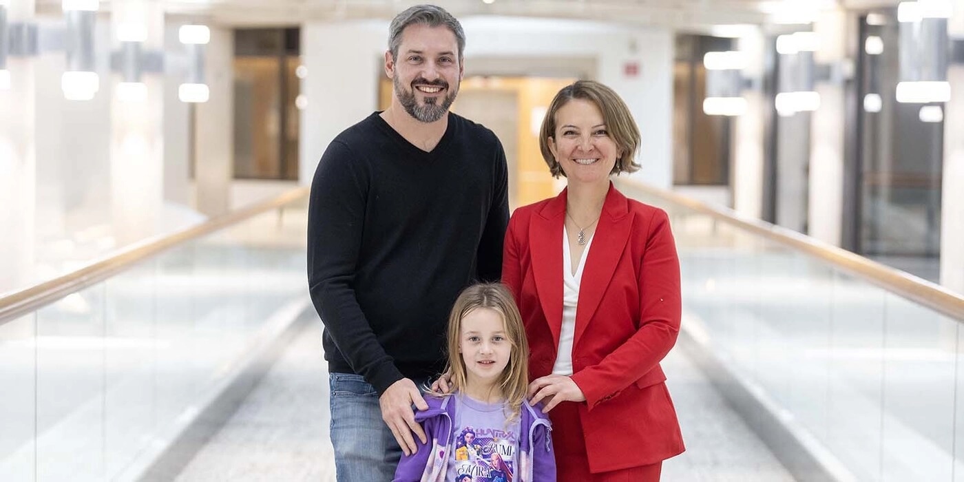 ick Smith and his daughter, Adela, stand and smile with Dr. Gumus Balikcioglu outside of the pediatric lipid disorders clinic.