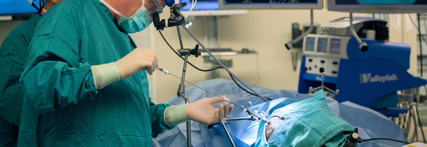 Neurosurgeon John Sampson, MD, places a catheter into the brain of a patient with malignant glioblastoma