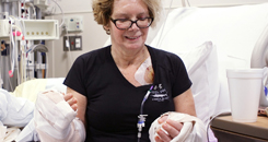 Woman looks in wonder at her hands post-transplant