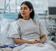 Woman sitting up in a hospital bed