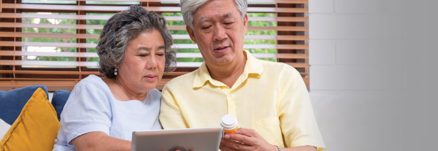 Older couple looks medication information together
