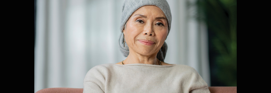 A woman with cancer wearing a head covering