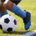 Close up of feet of young boy playing soccer
