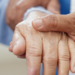 Physician examining patient's hand tremor