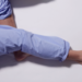 Man With RLS - Restless Legs Syndrome. Sleeping In Bed