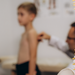 Doctor examines the back of a 5-year-old boy who has back pain