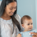 Female pediatrician checks heart of baby girl in medical appointment