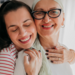Daughter arranges a scarf for her mother, cancer