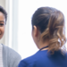 Mid adult woman receiving good news from nurse