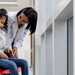 Doctor talking to a girl with cerebral palsy in a wheelchair at the hospital