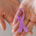Unrecognizable woman holding in her hands purple ribbon