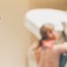 A patient getting a mammogram with the technician in the forefront