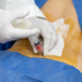 Doctor administering an injection to a senior patient's spine as a treatment 