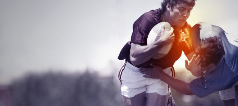 A rugby player being tackled during a game and sustaining an injury