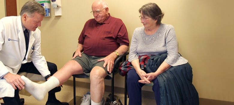 Physician examing patient's leg